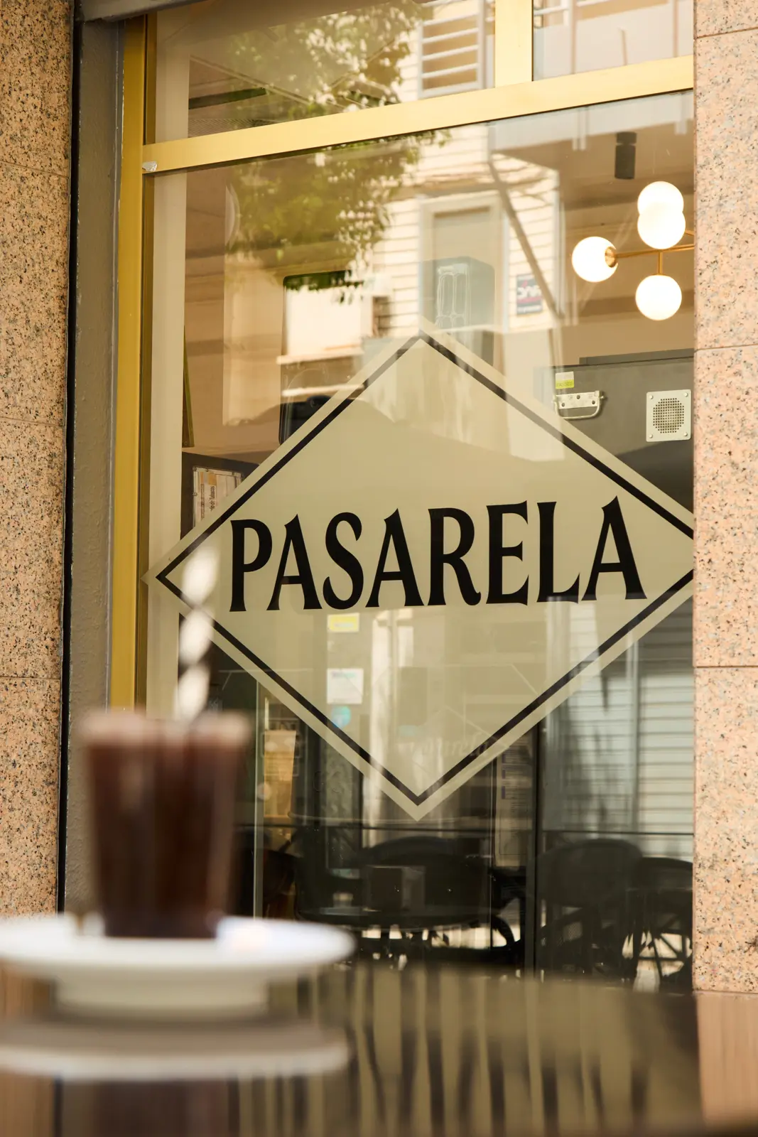 Logotipo de Pasarela en la cristalera de la cafetería